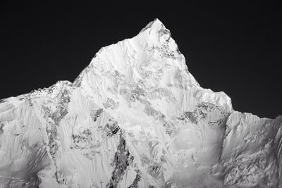 Majestic shot of snow capped mountain against clear sky