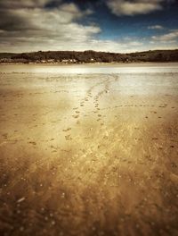 Close-up of sand on beach against sky