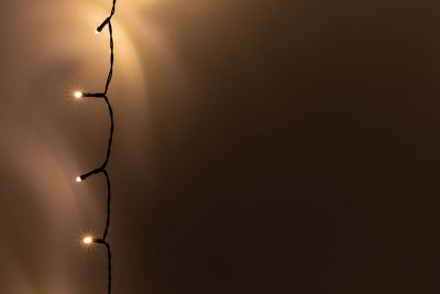 Low angle view of illuminated lights hanging from ceiling