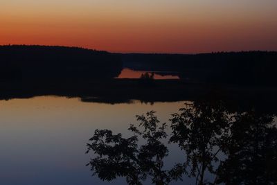 Scenic view of lake against orange sky
