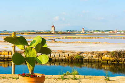 Scenic view of lake by building against sky