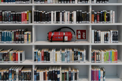 Bookshelves public library with fire extinguisher. stuttgart germany. clean white ambiance.