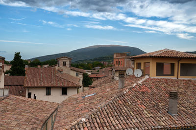 Houses in town against sky