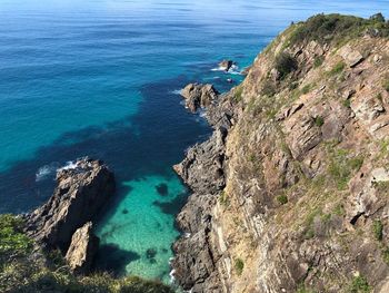 High angle view of rocks on sea shore