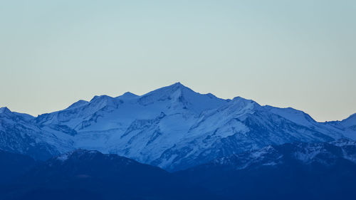 Scenic view of snowcapped mountains against clear sky