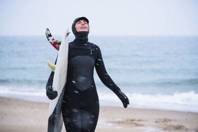 Young woman going winter surfing in snow