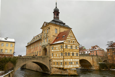 Low angle view of arch bridge and buildings against sky