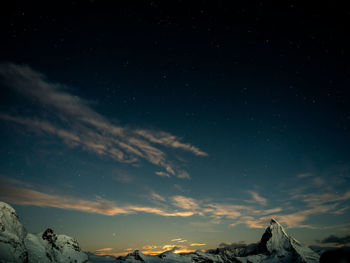 Scenic view of mountains against sky at night