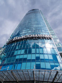 Low angle view of modern building against cloudy sky