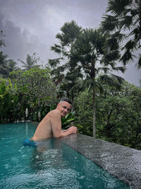 Portrait of young man swimming in lake