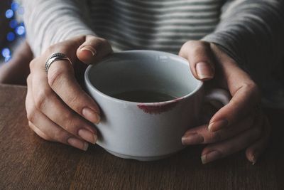 A girl holding a cup of tea