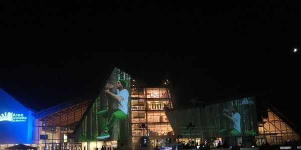 Low angle view of illuminated buildings in city at night