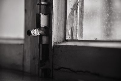 Close-up of old-fashioned latch on window at home