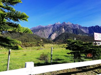 Scenic view of mountains against blue sky