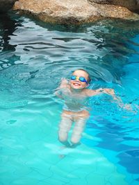 Portrait of boy swimming in pool