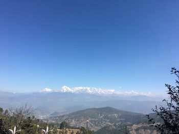 Scenic view of mountains against clear blue sky