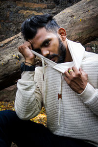 Portrait of young man sitting outdoors