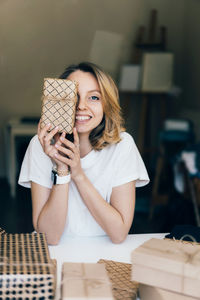 Portrait of a smiling young woman holding ice cream