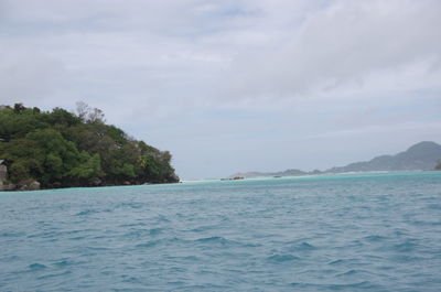 Scenic view of sea against cloudy sky