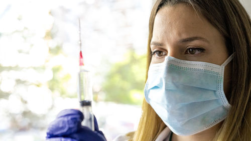 Close-up of female doctor holding syringe