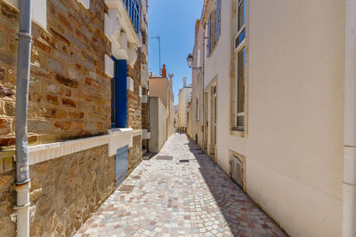 Footpath amidst buildings in city