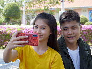 Portrait of smiling couple taking selfie with mobile phone