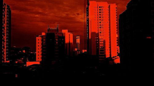 Illuminated cityscape against sky at night