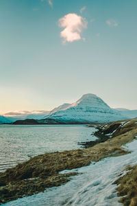 Snowy mountain near sea bay landscape photo