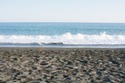 Scenic view of beach against clear sky