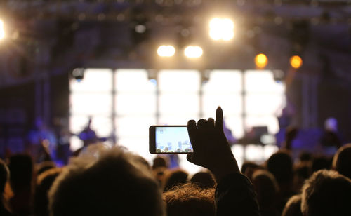 Person records a video of the live concert with the modern smartphone