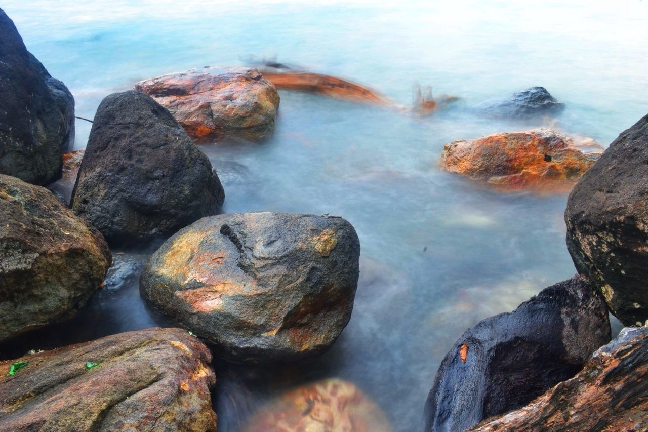 water, rock - object, rock formation, rock, beauty in nature, nature, sea, tranquility, scenics, tranquil scene, stone - object, stone, high angle view, idyllic, outdoors, day, rocky, shore, geology, no people