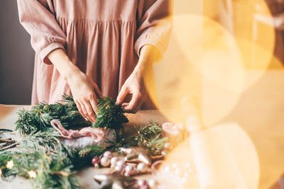 Midsection of woman preparing christmas decoration