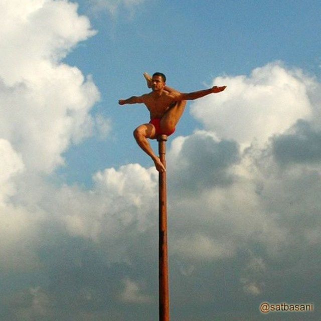 sky, low angle view, cloud - sky, cloud, cloudy, one person, full length, outdoors, human representation, day, arms outstretched, jumping, sculpture, arms raised, art, mid-air, art and craft, nature, leisure activity, statue