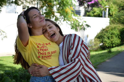 Rear view of mother and daughter smiling