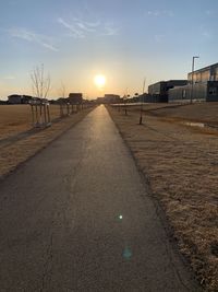 Street against sky during sunset