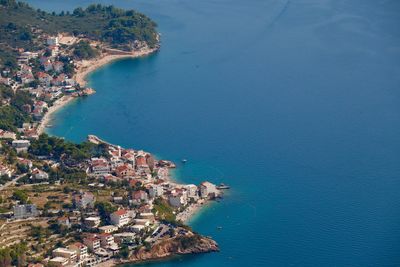 High angle view of townscape by sea