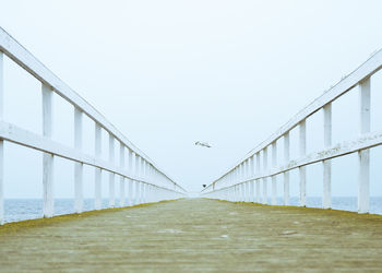 Bridge over sea against clear sky