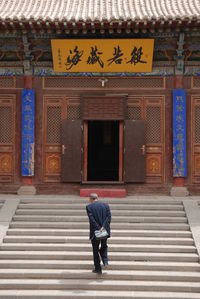 Full length of woman standing by railing