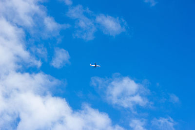 Low angle view of airplane flying in sky