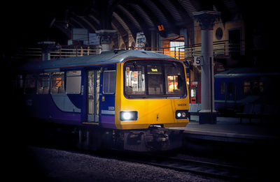 Train on street in city at night