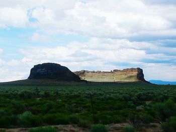 Scenic view of landscape against cloudy sky