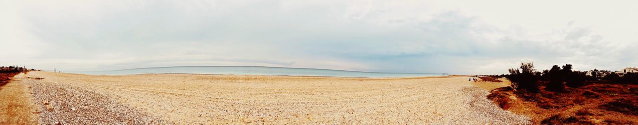 Panoramic view of desert land against sky