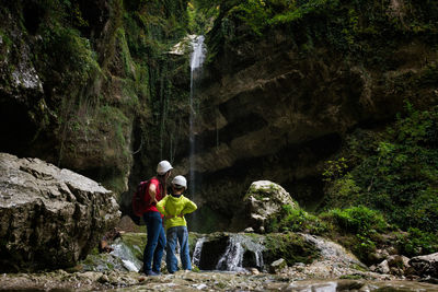 Rear view of family walking on rock