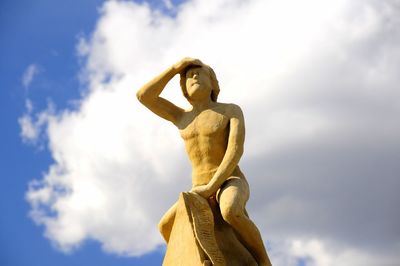 Low angle view of statue against cloudy sky