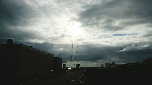 Buildings in city against cloudy sky