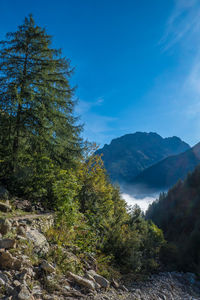 Scenic view of mountains against blue sky