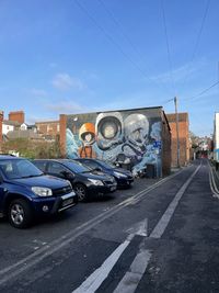 Cars on road against blue sky