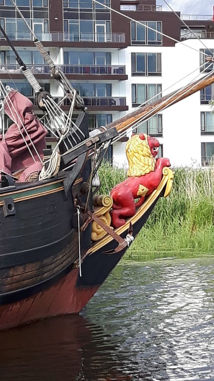 BOAT MOORED IN CITY BY WATER