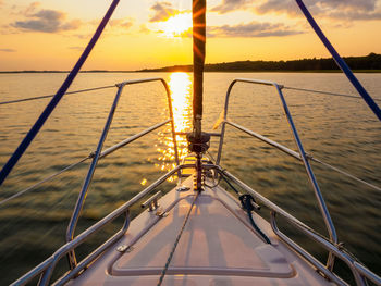 Sailing yacht bow in sunset light, sailing on a lake