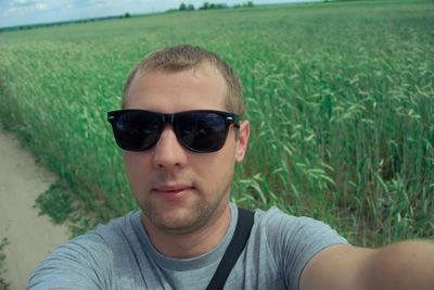 Close-up portrait of young man wearing sunglasses